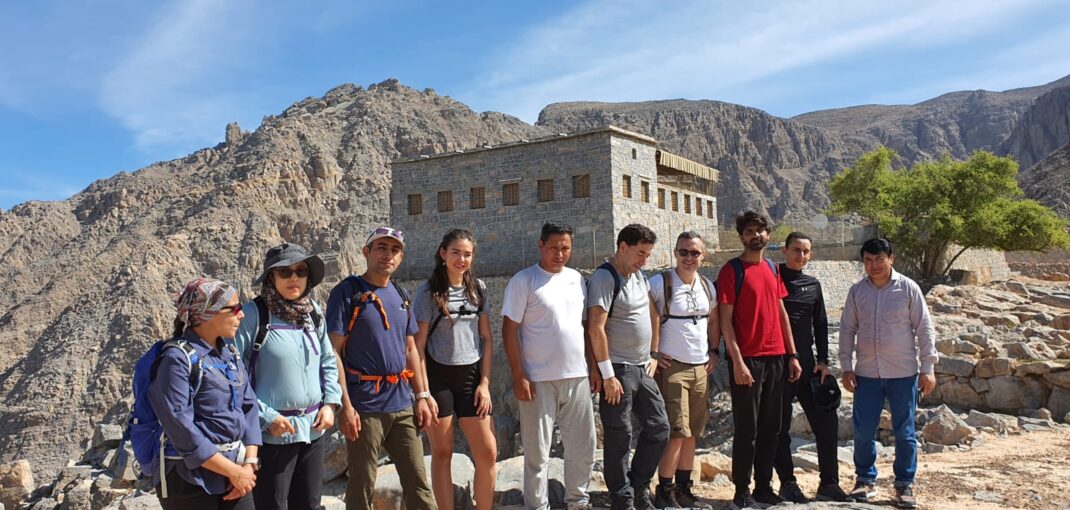 Group of hikers exploring Sherry Village in the UAE mountains