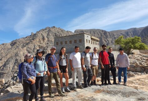 Group of hikers exploring Sherry Village in the UAE mountains