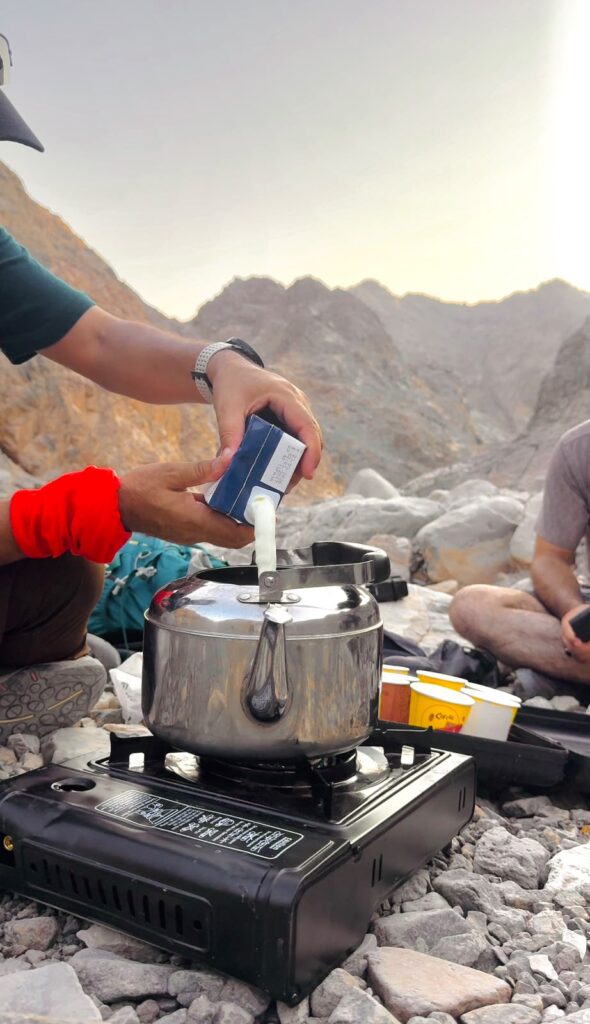 Preparing Alpine Trekkers signature chai during a mountain hiking break in the UAE